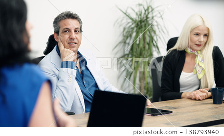 Smiling business people having meeting in office boardroom Smiling business people having meeting in office boardroom 138793940