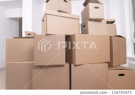 Collection of cardboard boxes stacks in a light room Collection of cardboard boxes stacks in a light room 138793975