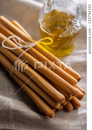 Rustic Grissini Breadsticks Bundle Tied With String on Linen Cloth, Closeup Food Still Life 138794162