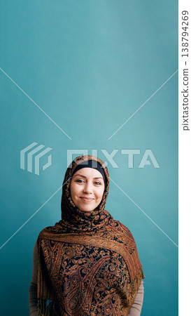 Muslim woman wearing paisley hijab smiling at camera Muslim woman wearing paisley hijab smiling at camera 138794269