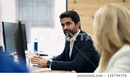 Businessman leading a discussion during an office meeting Businessman leading a discussion during an office meeting 138794356
