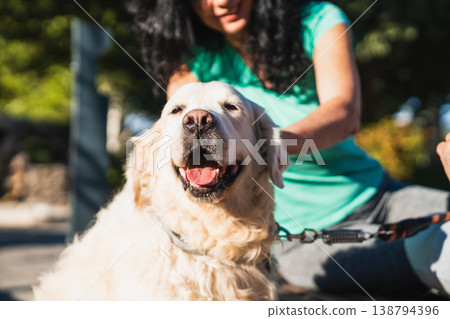 Happy golden retriever puppy enjoying outdoor pet care Happy golden retriever puppy enjoying outdoor pet care 138794396