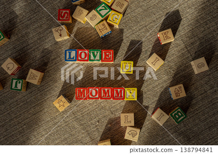Colorful childrens wooden blocks making words love you mommy. Colorful childrens wooden blocks making words love you mommy. 138794841
