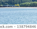 A yellow Kiha 40 train runs across a railway bridge over the Hosoda River, which flows into the Odotsu Beach in Nichinan City, Miyazaki Prefecture. 138794846