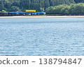 A yellow Kiha 40 train runs across a railway bridge over the Hosoda River, which flows into the Odotsu Beach in Nichinan City, Miyazaki Prefecture. 138794847