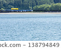 A yellow Kiha 40 train runs across a railway bridge over the Hosoda River, which flows into the Odotsu Beach in Nichinan City, Miyazaki Prefecture. 138794849