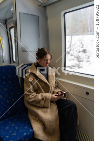 Young Woman Working Remotely on Train During Winter Travel. Young Woman Working Remotely on Train During Winter Travel. 138795022