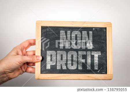Non Profit Text on Chalkboard Held by Hand Representing Charity and Social Impact Non Profit Text on Chalkboard Held by Hand Representing Charity and Social Impact 138795055