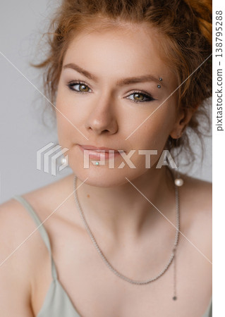 Close up portrait of smiling young Caucasian redhead woman with green eyes, white background 138795288