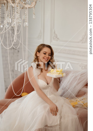 Elegant Bride Holding Tiny Birthday Cake. Caucasian Woman In Corset Posing With Cake And Candles 138795304