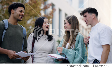University students talking and laughing on campus 138795489