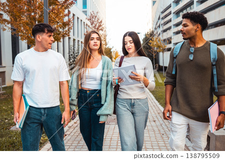 Diverse group of young adult students walking on campus path 138795509