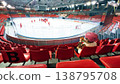 Little girl watching ice hockey training in indoor arena stands 138795708