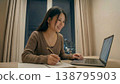 A young woman studying 138795903
