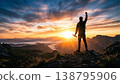 A man strikes a triumphant pose at the mountaintop. 138795906
