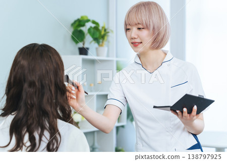 Female staff with light-colored hair doing makeup Female staff with light-colored hair doing makeup 138797925