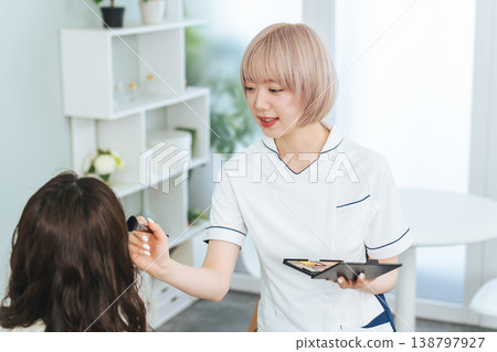 Female staff with light-colored hair doing makeup 138797927