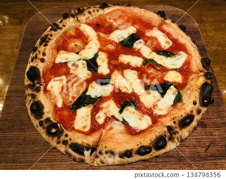 A delicious-looking Margherita pizza with a nice char. A delicious-looking Margherita pizza with a nice char. 138798356