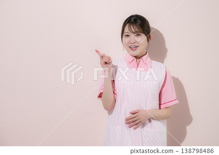 A pink background image of a woman working as a caregiver or childcare worker, highlighting the rewarding nature of her home care work and the importance of pointing to key points. A pink background image of a woman working as a caregiver or childcare worker, highlighting the rewarding nature of her home care work and the importance of pointing to key points. 138798486