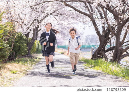 New first grader running in a park where cherry blossoms bloom 138798809