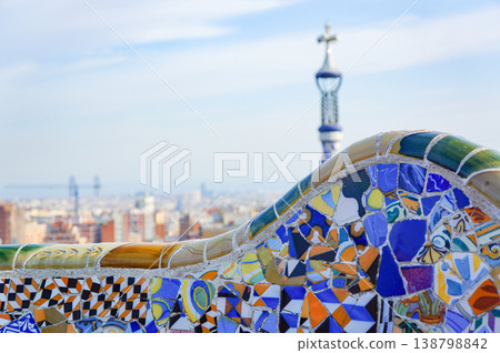 The colorful ceramic benches in Park Güell and the stunning view overlooking Barcelona city. The colorful ceramic benches in Park Güell and the stunning view overlooking Barcelona city. 138798842