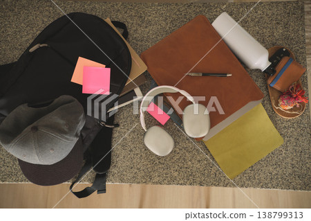 Student backpack and study items on granite surface 138799313