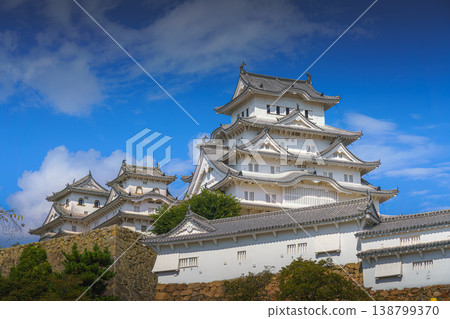 Himeji, Japan - Sep 24 2024, Panoramic view of Himeji Castle, White Heron Castle with trees and plants of park on foreground, at daytime with blue cloudy sky, without people, Himeji, Japan 138799370