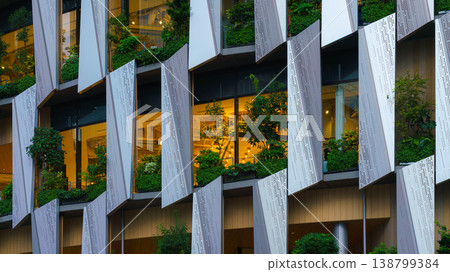 Osaka, Japan - Sep 25 2024, A close-up view of the facade of a modern Hanshin Department Store skyscraper, with hydrangea and trees growing on windows, without people, at daytime, Osaka, Japan 138799384