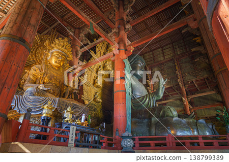 Nara, Japan - Sep 26 2024, Panoramic view of the Sitting Buddha Vairochana, a fifteen-meter bronze statue of Buddha, and a side-standing gilded statue of Buddha, at Todaiji Temple, Nara, Japan Nara, Japan - Sep 26 2024, Panoramic view of the Sitting Buddha Vairochana, a fifteen-meter bronze statue of Buddha, and a side-standing gilded statue of Buddha, at Todaiji Temple, Nara, Japan 138799389