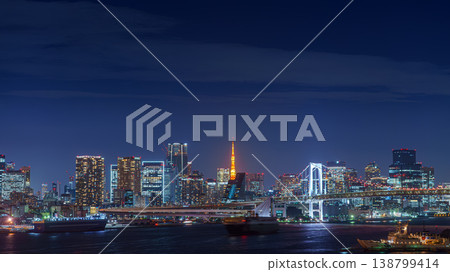 Tokyo, Japan - Oct 2 2024, panoramic aerial view of Tokyo Bay cityscape with skyscrapers in background and the Rainbow Bridge, at nighttime with illumination, Tokyo, Japan Tokyo, Japan - Oct 2 2024, panoramic aerial view of Tokyo Bay cityscape with skyscrapers in background and the Rainbow Bridge, at nighttime with illumination, Tokyo, Japan 138799414