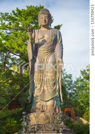 Sakata, Yamagata, japan - Oct 5 2024, A vertical view of the giant Great Buddha statue at Jichi-In Temple, with trees in the background, at daytime, Sakata, Japan 138799423