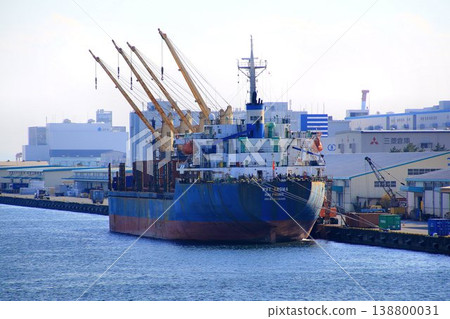 A bulk carrier docked and during cargo handling. A bulk carrier docked and during cargo handling. 138800031