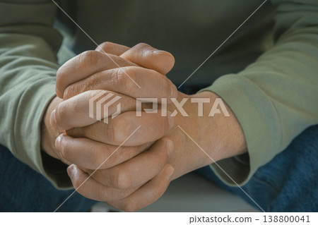 Clasped hands close up calm moment Clasped hands close up calm moment 138800041