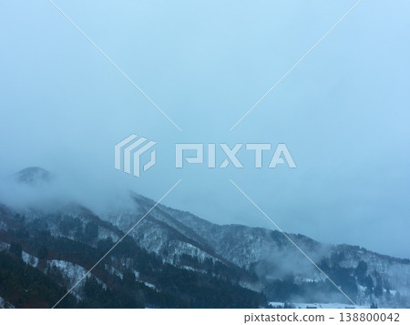 Snow-covered mountains and fog: Winter mountain scenery Snow-covered mountains and fog: Winter mountain scenery 138800042