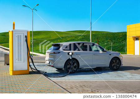 Electric car charging station with vehicle parked during sunny day Electric car charging station with vehicle parked during sunny day 138800474