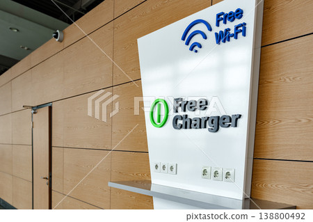 Sign showing free wifi and charging station in a busy public area Sign showing free wifi and charging station in a busy public area 138800492