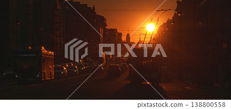 Saint-Petersburg, Russia - April 10 2026, panoramic view of Nevsky Prospect, cars on road, people walking on sidewalk, at sunset with bright sun, everything in orange light, St Petersburg, Russia Saint-Petersburg, Russia - April 10 2026, panoramic view of Nevsky Prospect, cars on road, people walking on sidewalk, at sunset with bright sun, everything in orange light, St Petersburg, Russia 138800558