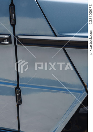 Close view of a blue vehicle door showing details of paint and design in sunlight Close view of a blue vehicle door showing details of paint and design in sunlight 138800678