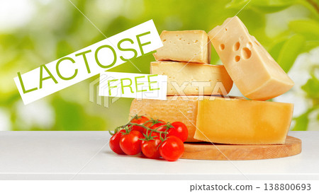 Lactose gluten free cheese and fresh tomatoes on a wooden board in a bright kitchen Lactose gluten free cheese and fresh tomatoes on a wooden board in a bright kitchen 138800693