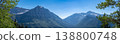 Panoramic view of mountain range with lush valley during clear daytime in nature 138800748
