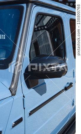 Close view of a blue vehicle with black carbon fiber side mirror on a sunny day Close view of a blue vehicle with black carbon fiber side mirror on a sunny day 138800768