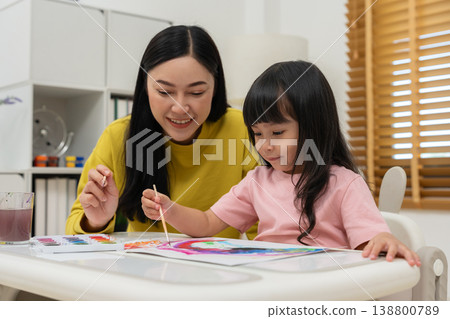 happy mother and preschool child girl painting on paper with watercolor in pan happy mother and preschool child girl painting on paper with watercolor in pan 138800789