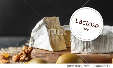 Cheese on a wooden board with almonds and a label indicating lactose free Cheese on a wooden board with almonds and a label indicating lactose free 138800815