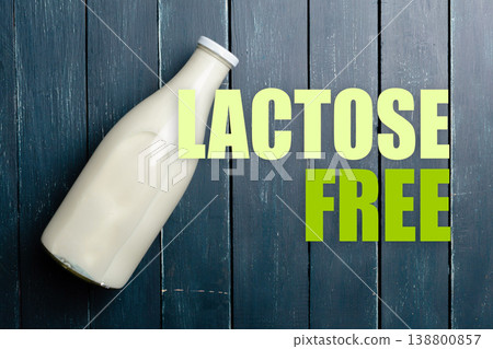 Lactose free milk on wooden surface with text representation of lactose free 138800857