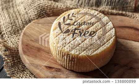 Cheese made without lactose and gluten on a wooden board in a kitchen setting Cheese made without lactose and gluten on a wooden board in a kitchen setting 138800899