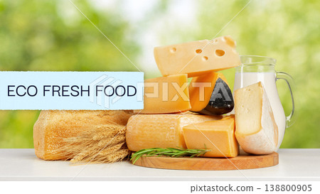 Lactose gluten free cheese on a table with milk and wheat in a sunny outdoor setting Lactose gluten free cheese on a table with milk and wheat in a sunny outdoor setting 138800905