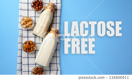 Bottles of lactose free milk with nuts lined on a table during day time Bottles of lactose free milk with nuts lined on a table during day time 138800911