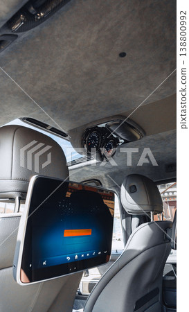 Smart display and dashboard in modern car interior with clear sky in background 138800992