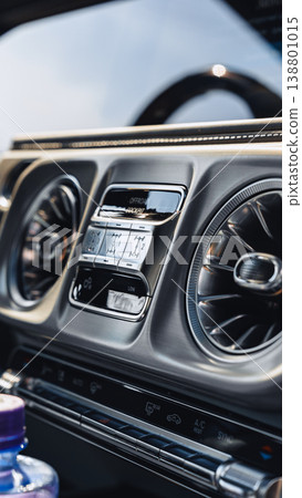 Controls and dashboard of a luxury car in modern design with clear display at daytime 138801015