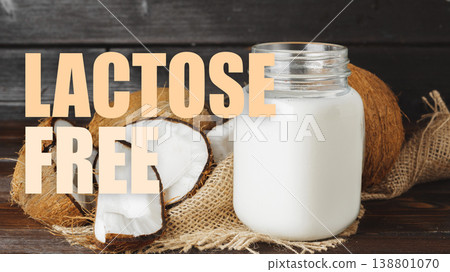 Coconut milk in jar with coconut pieces on wooden table labeled as lactose free Coconut milk in jar with coconut pieces on wooden table labeled as lactose free 138801070